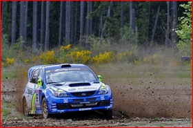 Travis Pastrana -- and guest -- taking a corner.  (Photo courtesy of Subaru Rally Team.)