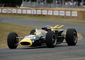 Jackie Stewart is shown at the wheel of a Lotus race car at Goodwood. (Photo by LAT Photographic.)
