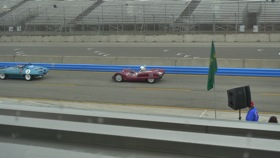 Historic race cars tearing around the Laguna Seca racetrack. (Photo by Josh Condon.)
