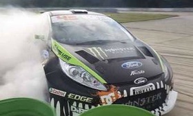 Ken Block smokes around l'Autodrome in the Gymkhana Three video. (Photo via AutoWeek.)