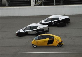 Two of Edison2's Very Light Cars (in silver and black) and one of the X-Tracer vehicles (in yellow) take to the track at the Michigan International Speedway during the finals of the Progressive Automotive Insurance X Prize. Edison2's Very Light Car No. 98, the car in the lead, won the top prize of $5 million, and the X-Tracer team won $2.5 million. (From MSNBC.)