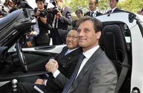 Lotus CEO Dany Bahar (right) presents an Elise to Toyota president Akio Toyoda. (Photo courtesy of Lotus.)