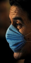 man wearing mask (© Photographer/AP Images)