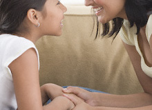 Mother and daughter talking (© Tom Grill/Corbis)