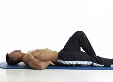 Man performing the McGill Curlup exercise